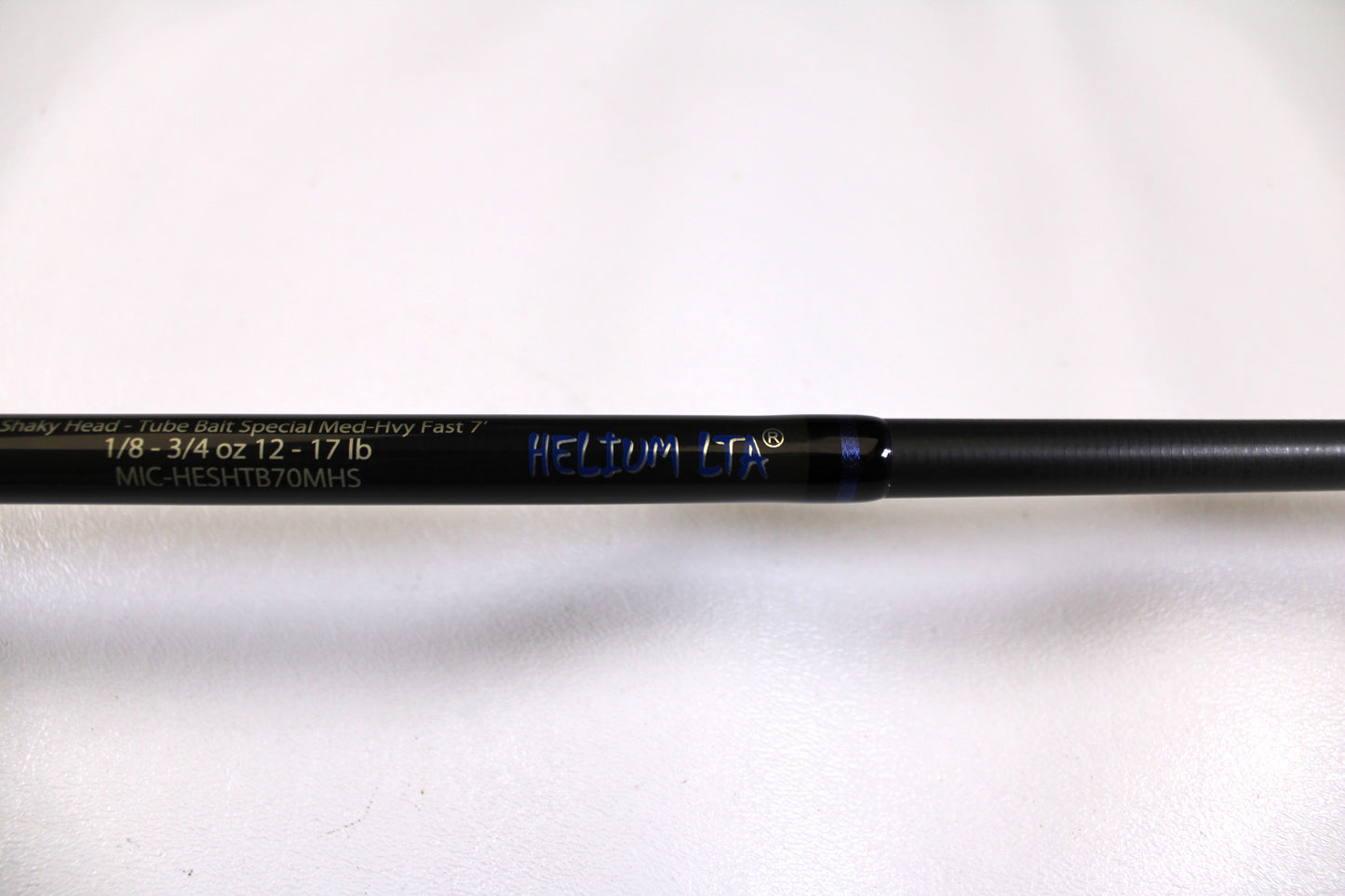 Close-up of a used Kistler Helium MIC-HESHTB70MHS 7'0" Medium Heavy spinning rod in excellent condition, with specs "1/8-3/4 OZ 12-17 LB"—ideal for our Rod and Reel Trade-In Program or store credit.