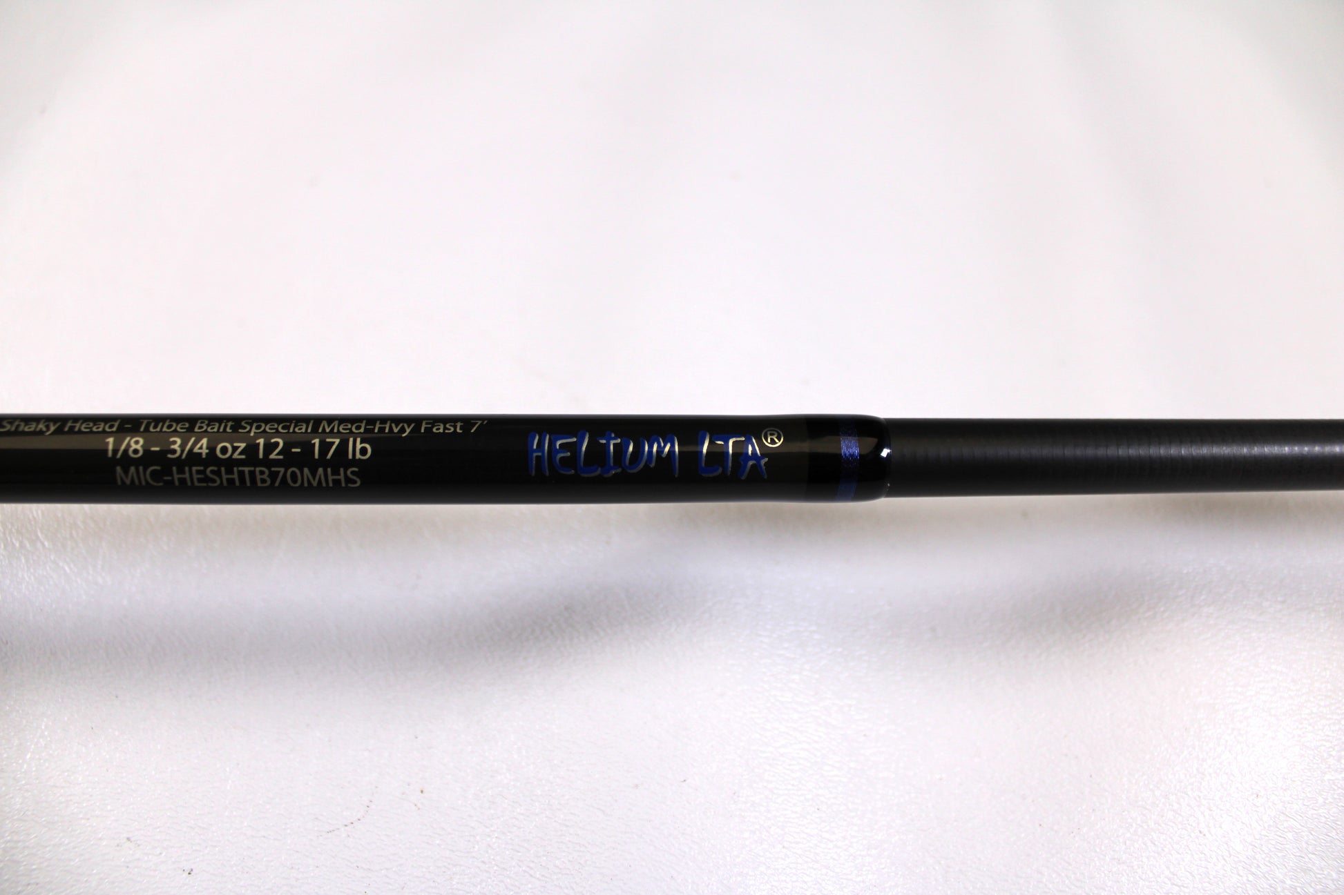 Close-up of a used Kistler Helium MIC-HESHTB70MHS 7'0" Medium Heavy spinning rod in excellent condition, with specs "1/8-3/4 OZ 12-17 LB"—ideal for our Rod and Reel Trade-In Program or store credit.