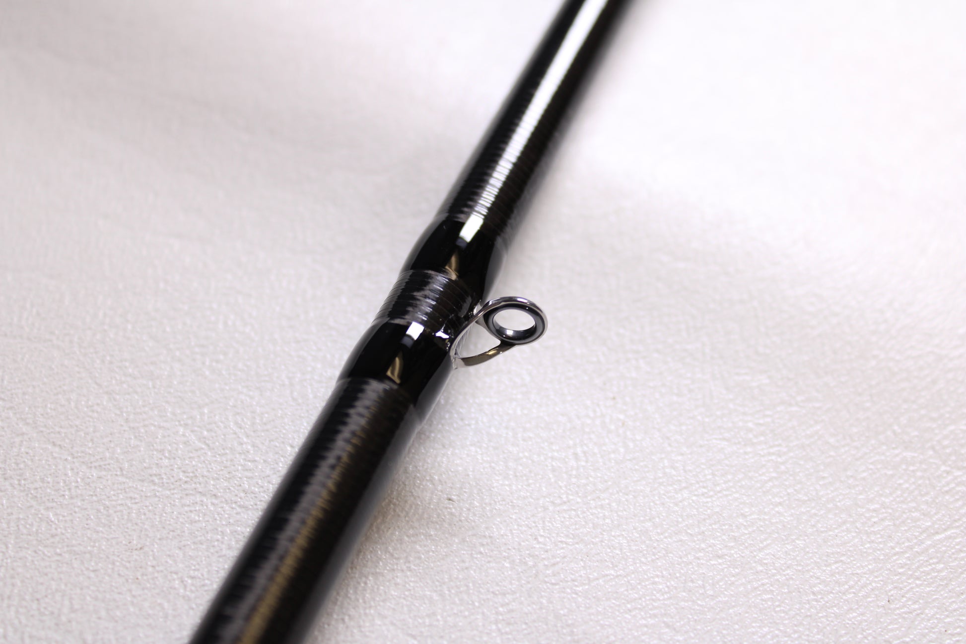 Close-up of a 13 Fishing Envy Black 3 EB3C76MH 7'6" Medium Heavy Used Casting Rod in mint condition, highlighting the metal guide ring—ideal for upgrading with our used gear or rod and reel trade-in programs.