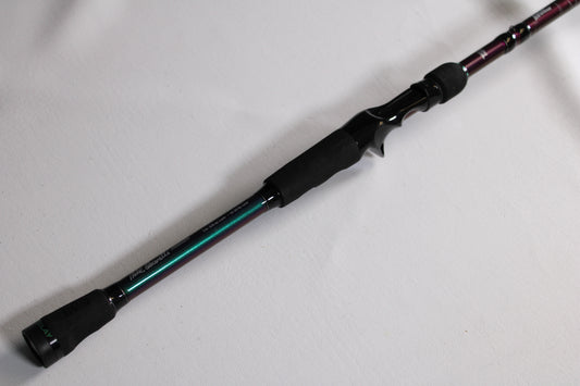 A close-up of the Abu Garcia Ike MIKECW70-5 7'0" Medium Delay Used Casting Rod in very good condition is shown diagonally on a white surface—ideal for those interested in our Rod and Reel Trade-In Program.