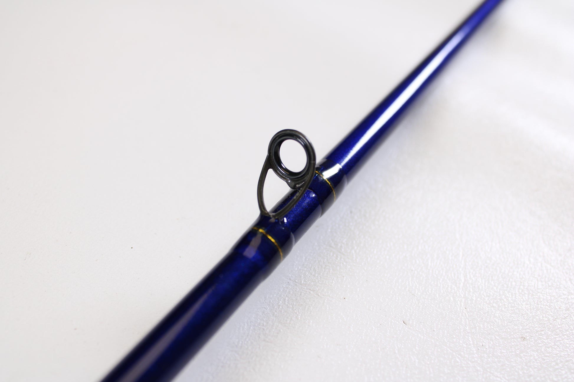 A close-up of the St. Croix Legend Tournament Pike Versatile Special LTPC216MHF 7'1" Medium Heavy Used Casting Rod, in excellent condition, highlights a black and silver guide ring against a white background—ideal for our trade-in program.