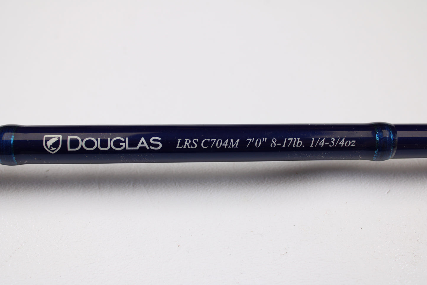 A close-up of the Douglas LRS C704M 7'0" Medium Used Casting Rod in very good condition, featuring white text on a blue rod—trade in your old gear for store credit with our Rod and Reel Trade-In Program.