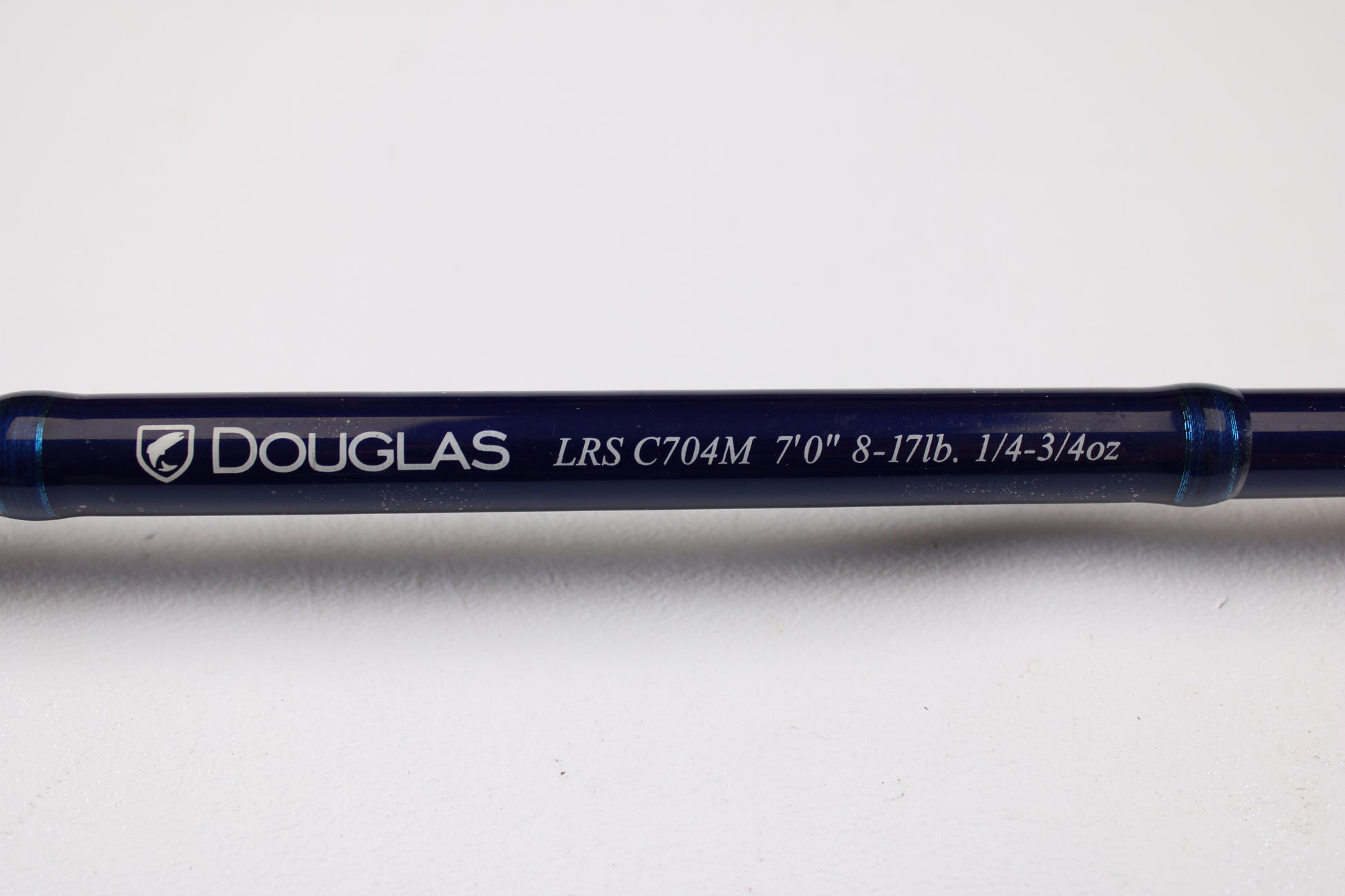 A close-up of the Douglas LRS C704M 7'0" Medium Used Casting Rod in very good condition, featuring white text on a blue rod—trade in your old gear for store credit with our Rod and Reel Trade-In Program.