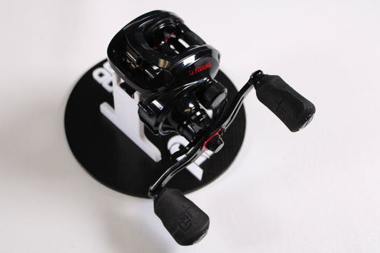 The 13 Fishing Inception G2 ING2P-5.3-LH 5.3:1 LH Used Casting Reel (Very Good Condition) is shown with dual foam handles on a marked black stand—ideal for upgrading via our Rod and Reel Trade-In Program or choosing quality used gear.