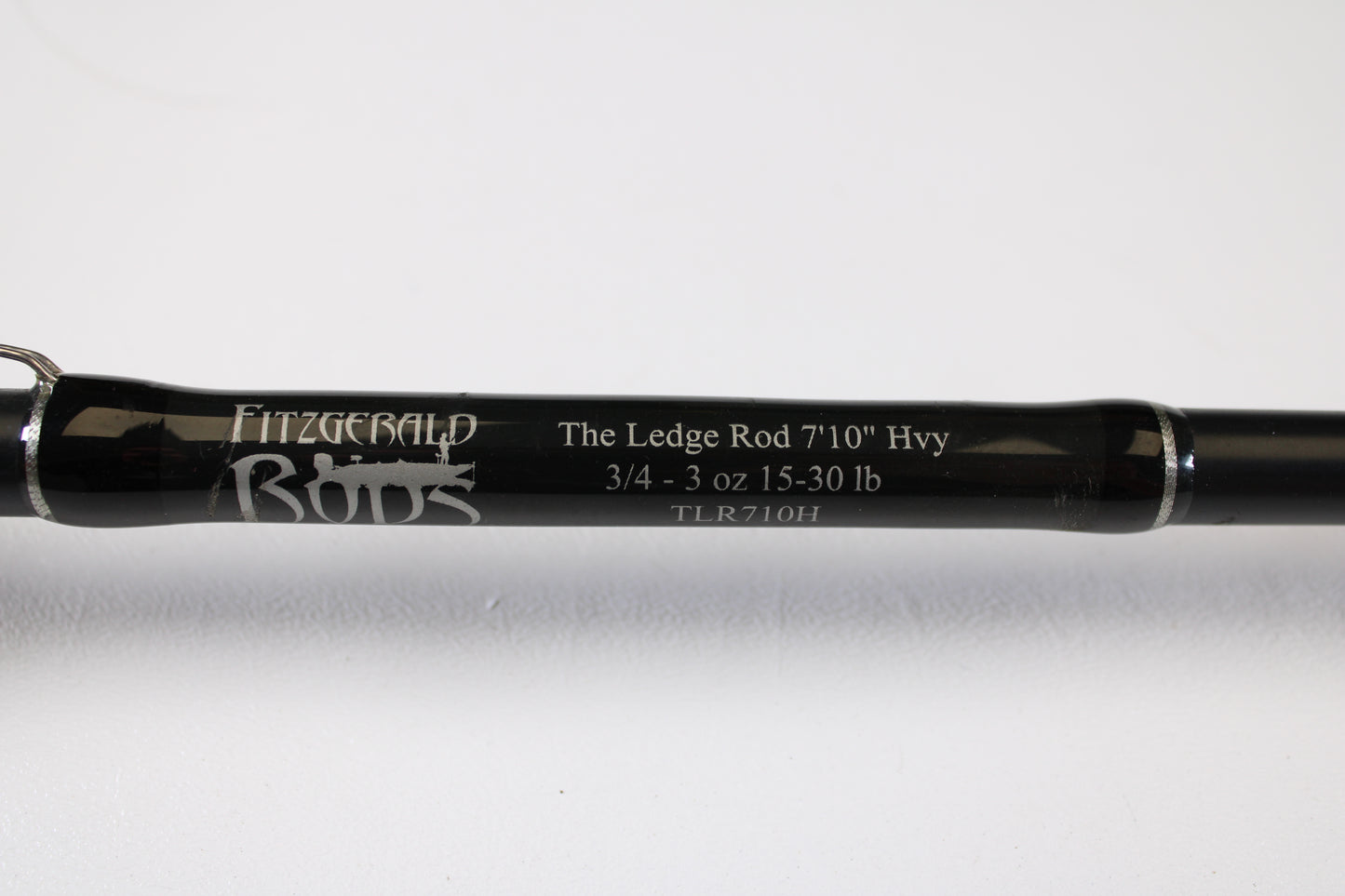 Close-up of a Fitzgerald Original TLR710H The Ledge Rod 7'10" Heavy Used Casting Rod (Very Good Condition) against a white background—ideal for anglers upgrading with our Rod and Reel Trade-In Program.