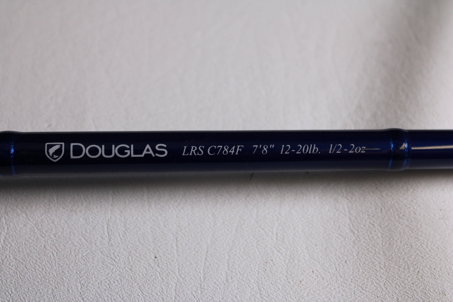 Close-up of a blue Douglas LRS LRSC784F 7'8" Medium Used Casting Rod in excellent condition—ideal for our rod and reel trade-in program or for earning store credit on used gear.