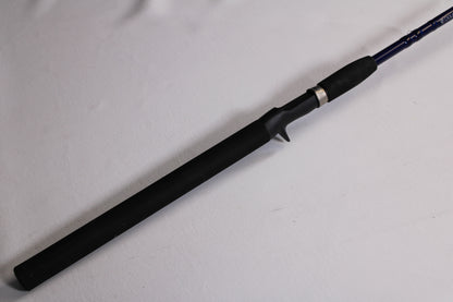 A close-up of the Douglas LRS LRSC7115F 7'11" Heavy used casting rod in excellent condition shows its black grip and trigger-style reel seat—ideal for those looking to trade in gear for store credit.