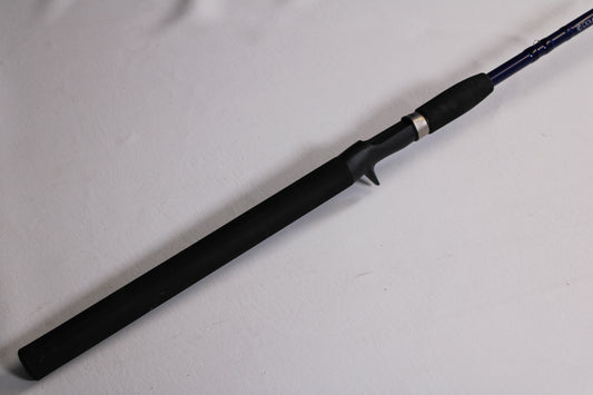 A close-up of the Douglas LRS LRSC7115F 7'11" Heavy used casting rod in excellent condition shows its black grip and trigger-style reel seat—ideal for those looking to trade in gear for store credit.