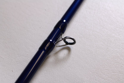 A close-up of the Douglas LRS LRSC7115F 7'11" Heavy Used Casting Rod shows its metal guide ring and fine craftsmanship—an ideal choice for anglers considering our Rod and Reel Trade-In Program for used Douglas fishing gear.