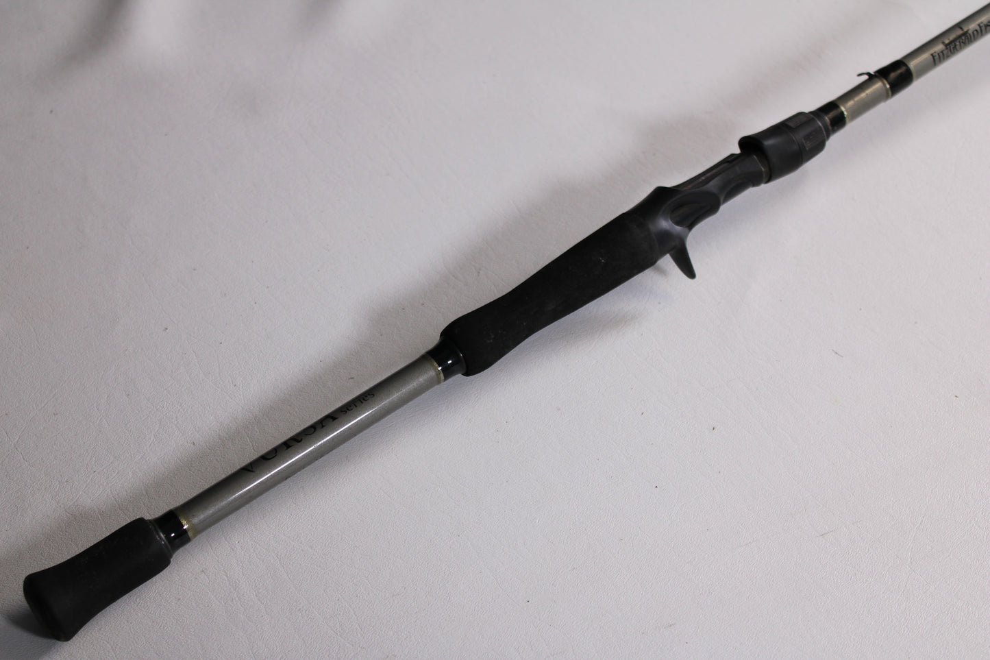A close-up of the Fitzgerald Vursa VS76H Pitchin' & Flippin' 7'6" Medium Used Casting Rod—Good Condition, with a black handle and trigger grip, ideal for those seeking quality pre-owned gear or our Rod and Reel Trade-In Program.