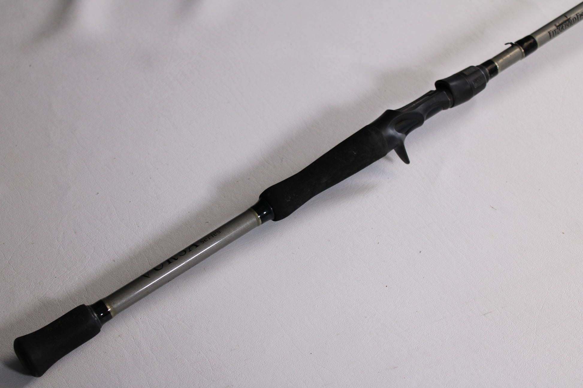 A close-up of the Fitzgerald Vursa VS76H Pitchin' & Flippin' 7'6" Medium Used Casting Rod—Good Condition, with a black handle and trigger grip, ideal for those seeking quality pre-owned gear or our Rod and Reel Trade-In Program.