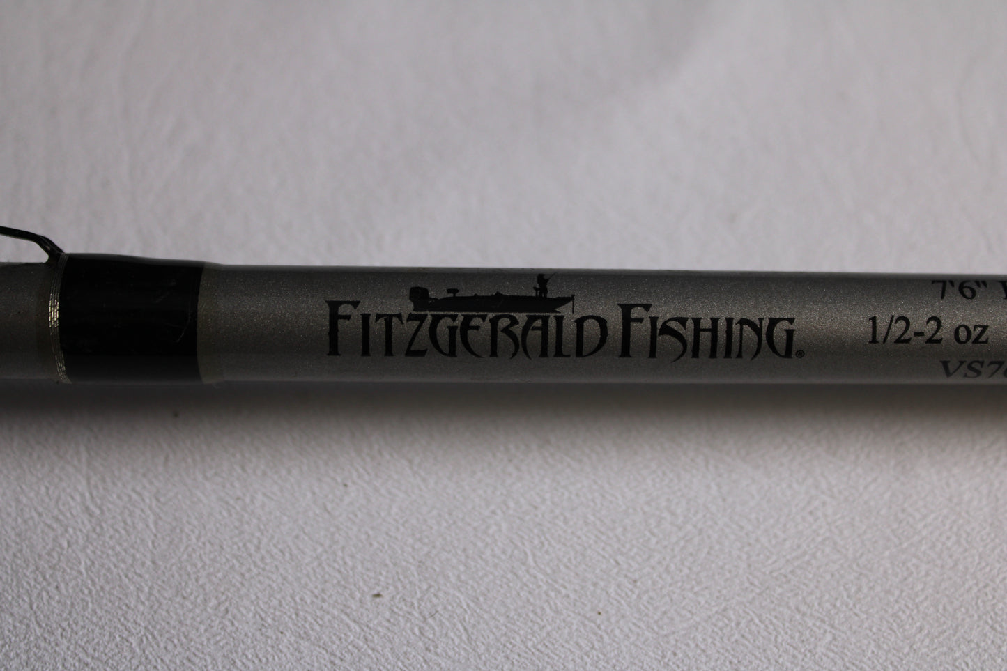 A close-up of the Fitzgerald Vursa VS76H Pitchin' & Flippin' 7'6" Medium used casting rod in good condition, with the Fitzgerald logo and specs—ideal for trading in through our Rod and Reel Trade-In Program.