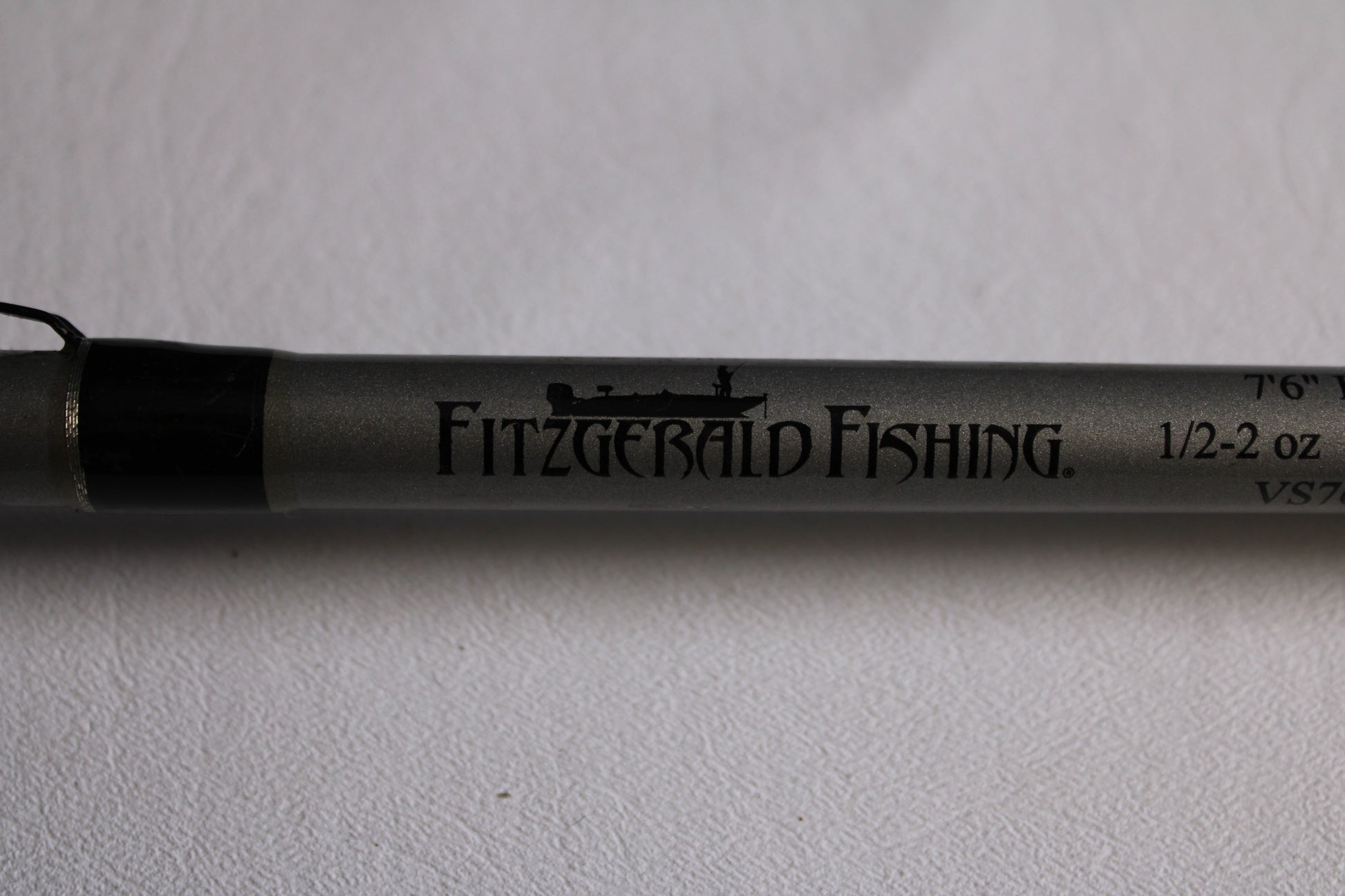 A close-up of the Fitzgerald Vursa VS76H Pitchin' & Flippin' 7'6" Medium used casting rod in good condition, with the Fitzgerald logo and specs—ideal for trading in through our Rod and Reel Trade-In Program.