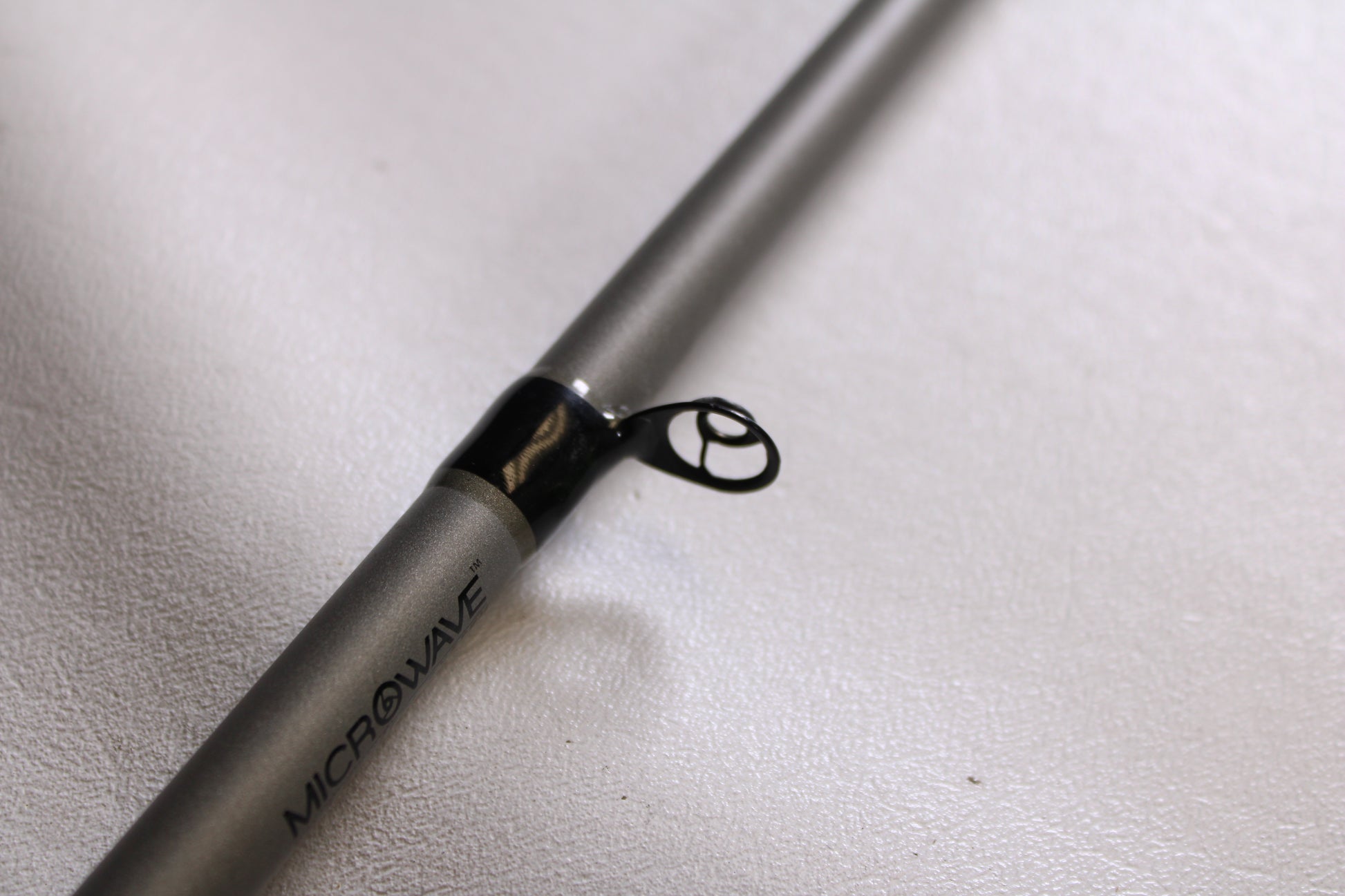 Close-up of a Fitzgerald Vursa VS76H Pitchin' & Flippin' 7'6" Medium Used Casting Rod in good condition, showing a black metal guide ring on a gray blank—ideal for anyone interested in our Rod and Reel Trade-In Program.