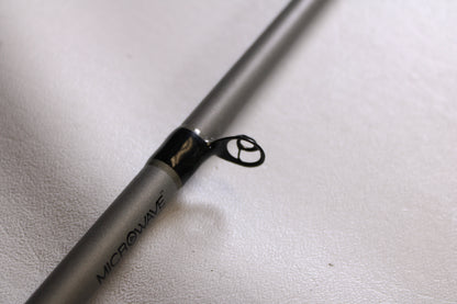 Close-up of a Fitzgerald Vursa VS76H Pitchin' & Flippin' 7'6" Medium Used Casting Rod in good condition, showing a black metal guide ring on a gray blank—ideal for anyone interested in our Rod and Reel Trade-In Program.