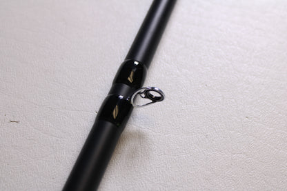 Close-up of the Fitzgerald Titan HD THD76H 7'6" Heavy - Used Casting Rod in very good condition, featuring a shiny silver guide ring—upgrade through our Rod and Reel Trade-In Program and earn store credit for your used Fitzgerald gear.
