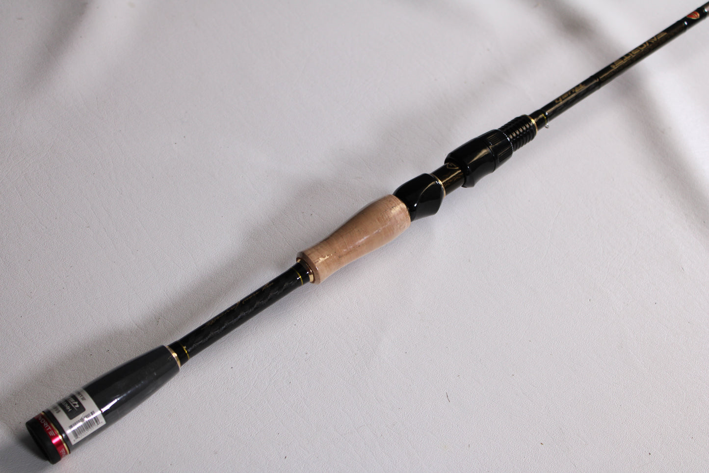 A close-up of the Evergreen Favorite Fishing Rush RUH-661MH 6'6" Medium Heavy Used Spinning Rod in excellent condition—ideal for highlighting quality gear from our Rod and Reel Trade-In Program.
