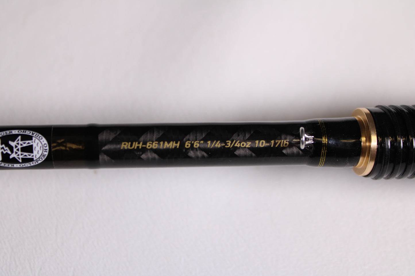 Close-up of the Favorite Fishing Rush RUH-661MH 6'6" Medium Heavy Used Spinning Rod in mint condition, featuring gold accents and model specs in yellow text—ideal for those interested in our rod and reel trade-in program.