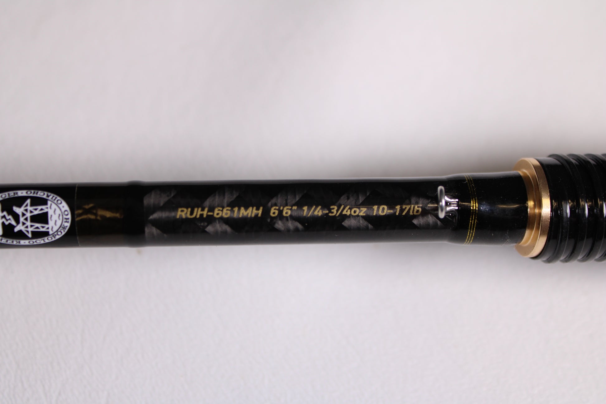 Close-up of the Favorite Fishing Rush RUH-661MH 6'6" Medium Heavy Used Spinning Rod in mint condition, featuring gold accents and model specs in yellow text—ideal for those interested in our rod and reel trade-in program.
