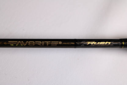 A close-up of the Favorite Fishing Rush RUH-661MH 6'6" Medium Heavy used spinning rod in mint condition, with "Favorite Fishing" and "Rush" in gold lettering, perfect for upgrading your fishing gear or adding to your collection.