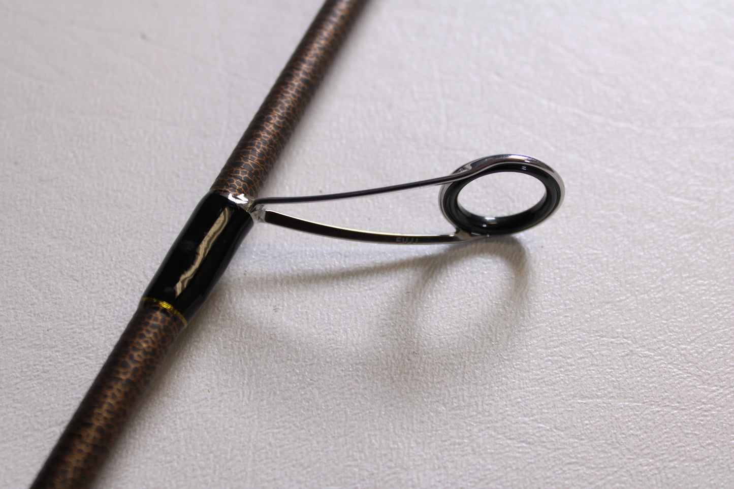 A close-up of the metal guide and support on the Favorite Fishing Rush RUH-661MH 6'6" Medium Heavy spinning rod—used, in mint condition—ideal for anglers shopping pre-owned gear or exploring our rod and reel trade-in program.