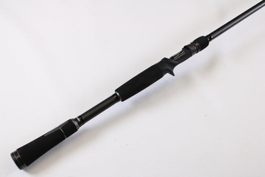 The 13 Fishing Muse 7'6" Medium Heavy Used Casting Rod (Excellent Condition) features a black finish, foam handle, and trigger grip—ideal for comfort and control. Upgrade it through our rod and reel trade-in program for store credit.