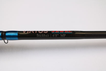 Close-up of a Jewel Virtus Stickbait 6'8" Medium Used Casting Rod in excellent condition, black and blue shaft, shown on white—ideal for anglers upgrading with our Rod and Reel Trade-In Program for store credit.