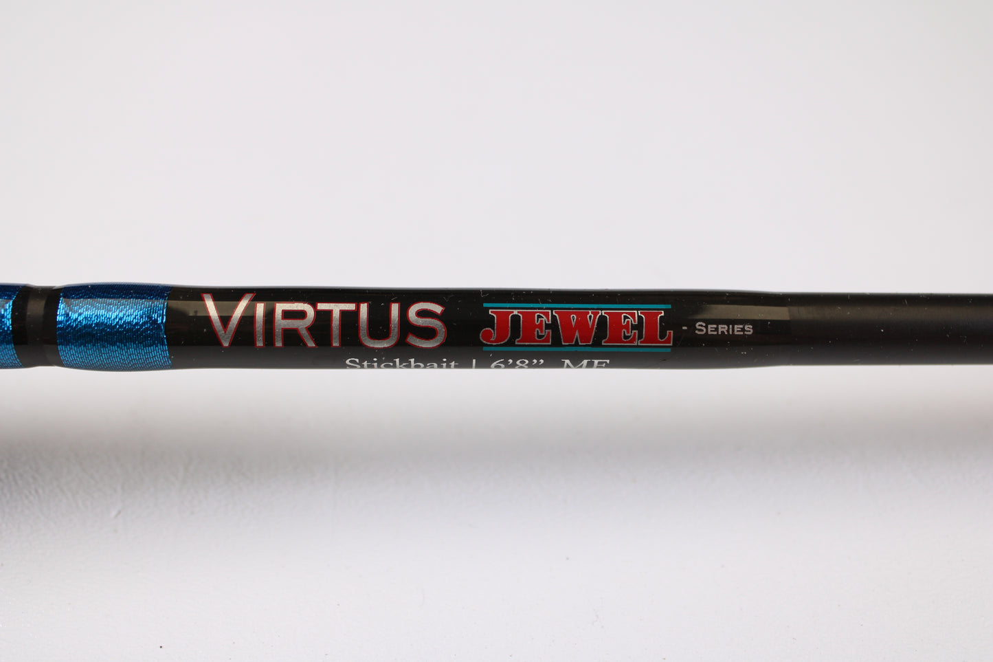 Close-up of a Jewel Virtus Stickbait 6'8" Medium Used Casting Rod in excellent condition, shown in black and metallic blue. Trade in your used gear with our Rod and Reel Trade-In Program for store credit!.