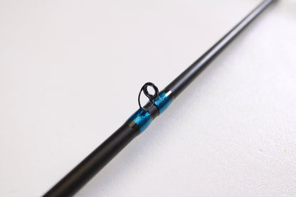 Close-up of the Jewel Virtus Stickbait 6'8" Medium Used Casting Rod in excellent condition, featuring a black finish and blue-wrapped guide ring—ideal for our Rod and Reel Trade-In Program or those wanting to upgrade their gear.