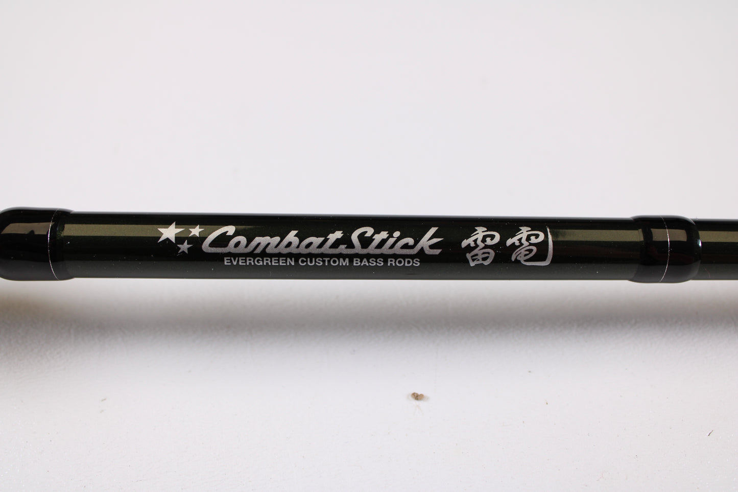 A close-up of the Evergreen Combat Stick RCTC-73MH Jig & Worm 7'3" Medium Heavy Used Casting Rod in excellent condition—ideal for store credit or trade-in, featuring stars, Japanese text, and "Evergreen Custom Bass Rods" in white.