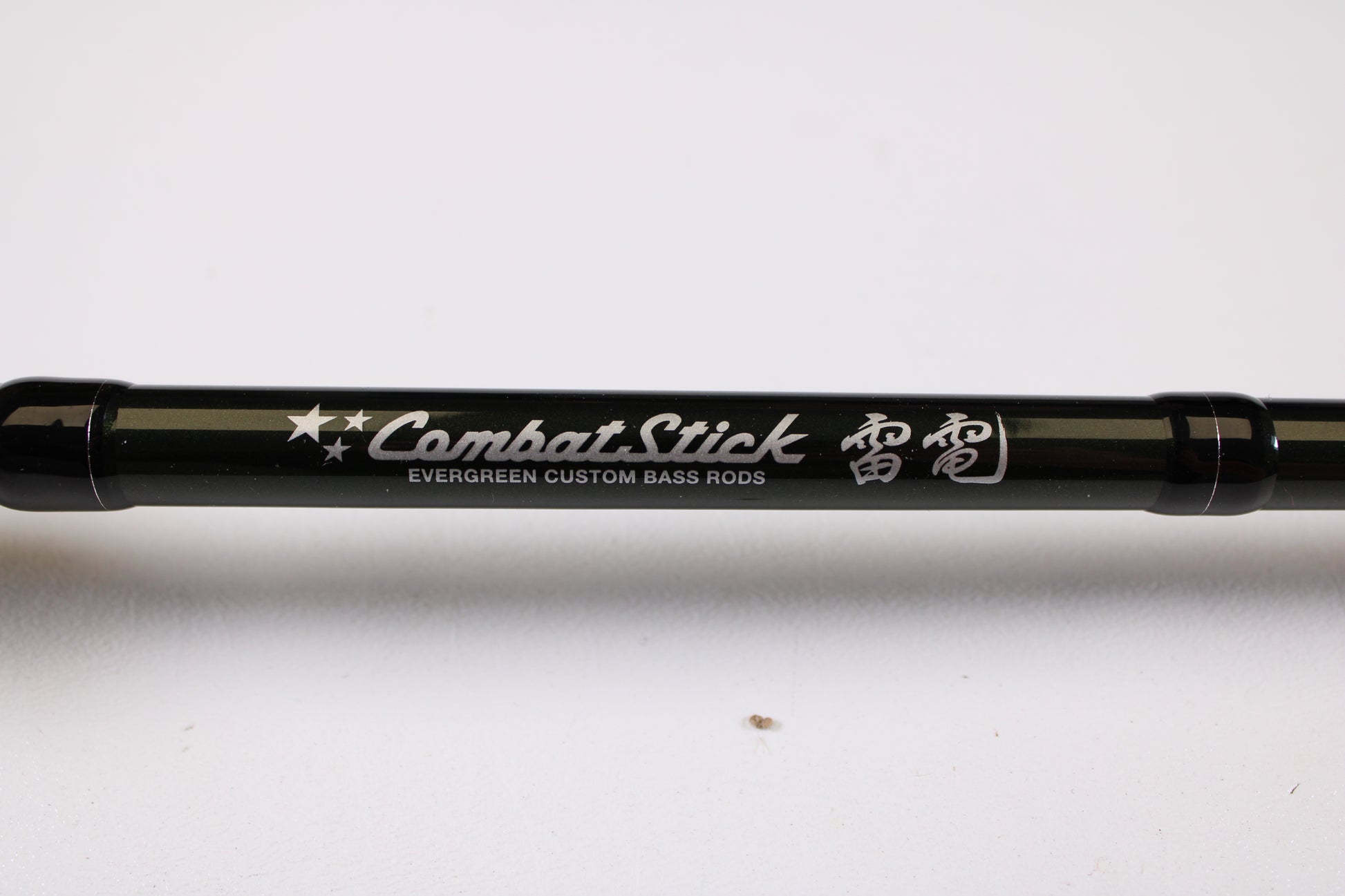 A close-up of the Evergreen Combat Stick RCTC-73MH Jig & Worm 7'3" Medium Heavy Used Casting Rod in excellent condition—ideal for store credit or trade-in, featuring stars, Japanese text, and "Evergreen Custom Bass Rods" in white.