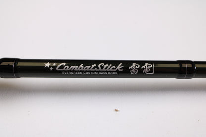 A close-up of the Evergreen Combat Stick RCTC-73MH Jig & Worm 7'3" Medium Heavy Used Casting Rod in excellent condition—ideal for store credit or trade-in, featuring stars, Japanese text, and "Evergreen Custom Bass Rods" in white.