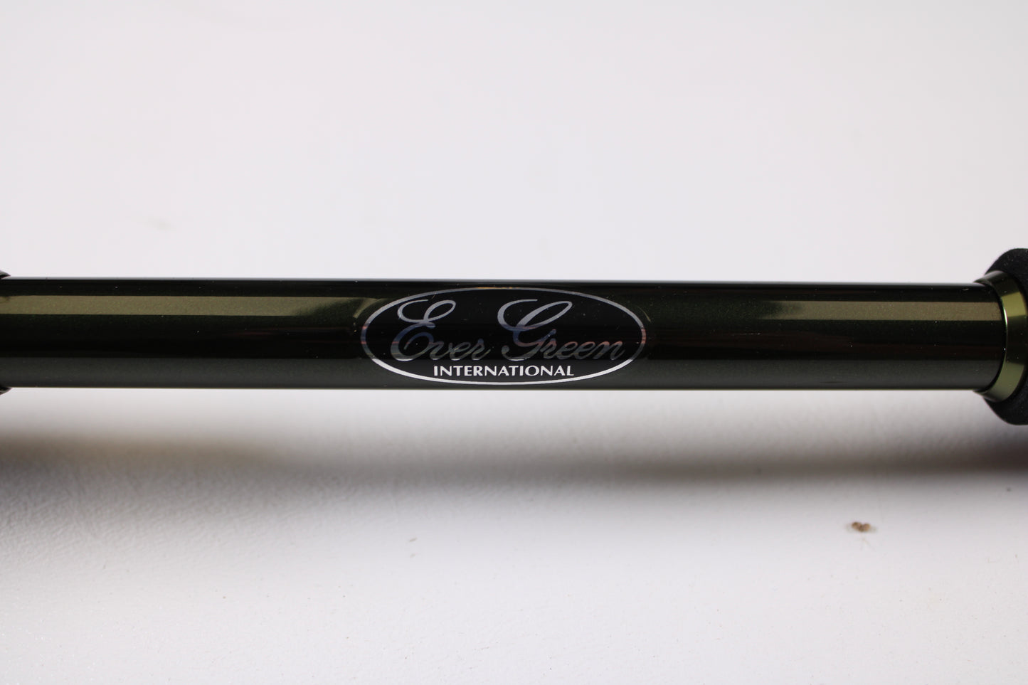 A close-up of the Evergreen Combat Stick RCTC-73MH Jig & Worm 7'3" Medium Heavy used casting rod in excellent condition, featuring the "Ever Green INTERNATIONAL" label on a black cylindrical body, shown horizontally on a white surface.