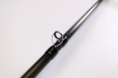 Close-up of the Evergreen Combat Stick RCTC-73MH Jig & Worm 7'3" Medium Heavy—Used Casting Rod in excellent condition, highlighting a metal line guide against a white background—great for those interested in rod trade-ins or used gear.