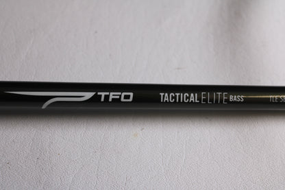 Close-up of a Temple Fork TFO Tactical Elite Bass TLE SB 726-1 7'2" Heavy Used Casting Rod (Excellent Condition) with white text on black—ideal for anglers seeking an upgrade through our rod and reel trade-in program.