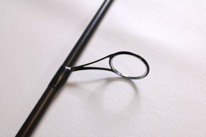 A close-up of a Temple Fork Outfitters GTS Bass S735-1 7'3" Medium Heavy used spinning rod guide, showing its smooth, metallic finish and secure attachment against a white background. Brand: Temple Fork. Condition: Excellent.