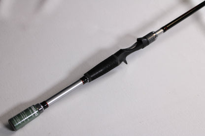 A close-up of a Shimano Intenza NTZC73H 7'3" Heavy used casting rod in mint condition, featuring a black grip and silver reel seat on a white background—ideal for those considering our rod and reel trade-in program.