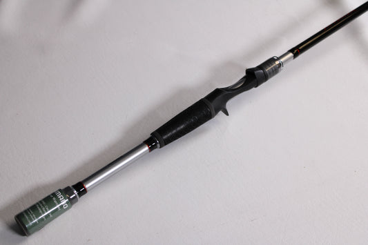 A close-up of a Shimano Intenza NTZC73H 7'3" Heavy used casting rod in mint condition, featuring a black grip and silver reel seat on a white background—ideal for those considering our rod and reel trade-in program.