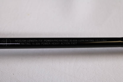 A close-up of the Shimano Intenza NTZC73H 7'3" Heavy Used Casting Rod in mint condition, ideal for our trade-in program. Specs: 30-65lb PowerPro, 1/2–1 1/2oz lure rating, 15-30lb line rating; heavy action, fast power.