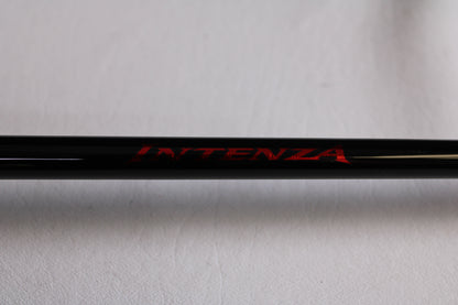 Close-up of a Shimano Intenza NTZC73H 7'3" Heavy used casting rod in mint condition, placed on a light gray background—perfect for anglers upgrading gear through our trade-in program to earn store credit.