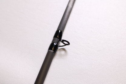 A close-up of a Shimano Intenza NTZC73H 7'3" Heavy Used Casting Rod in mint condition, highlighting the rod guide and shaft—ideal for those interested in our trade-in program to earn store credit for upgrading their gear.