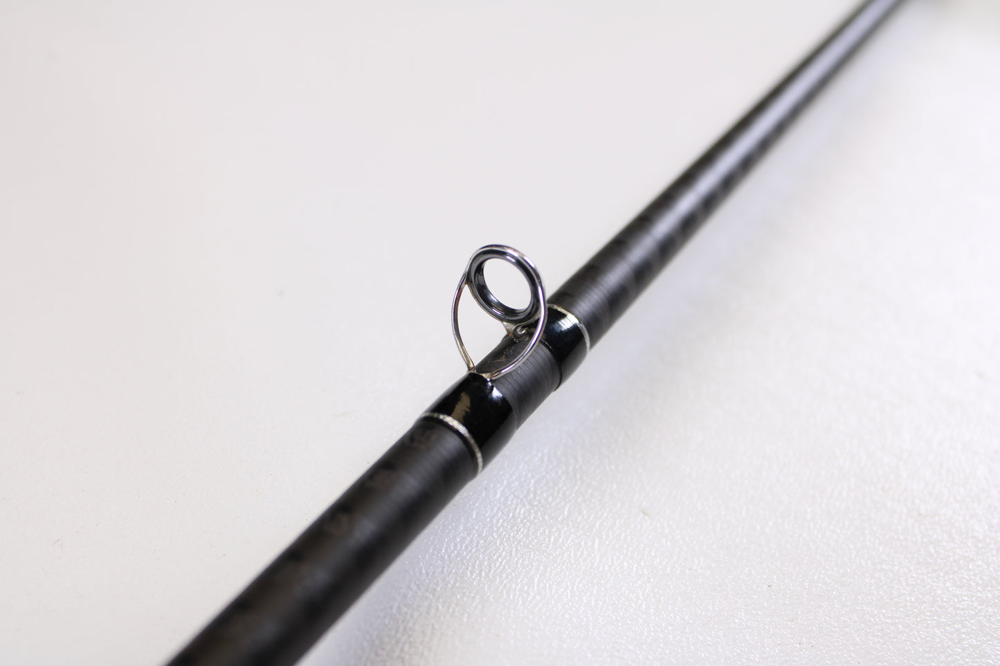 Close-up of a Shimano Expride B EXC72MHB 7'2" Medium Heavy Used Casting Rod in excellent condition, highlighting a metallic line guide—ideal for those trading in gear or upgrading with our Rod and Reel Trade-In Program.
