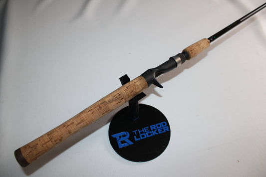 A St. Croix Premier PC66MF 6'6" Medium used casting rod in very good condition, featuring a cork handle, is displayed on a black stand labeled "The Rod Locker"—ideal for shoppers seeking used gear or trade-in options.