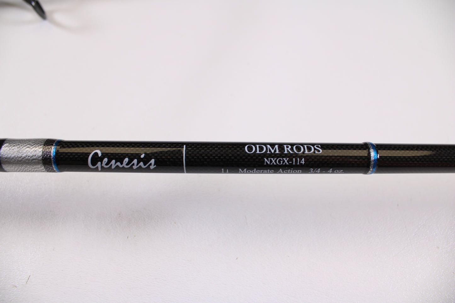Close-up of the ODM Rods Genesis Surf NGX-114 11'0" 2-Piece Used Spinning Rod in excellent condition, featuring "Moderate Action 3/4 - 4 oz" specs and blue accent rings—ideal for store credit trade-in or used gear listings.