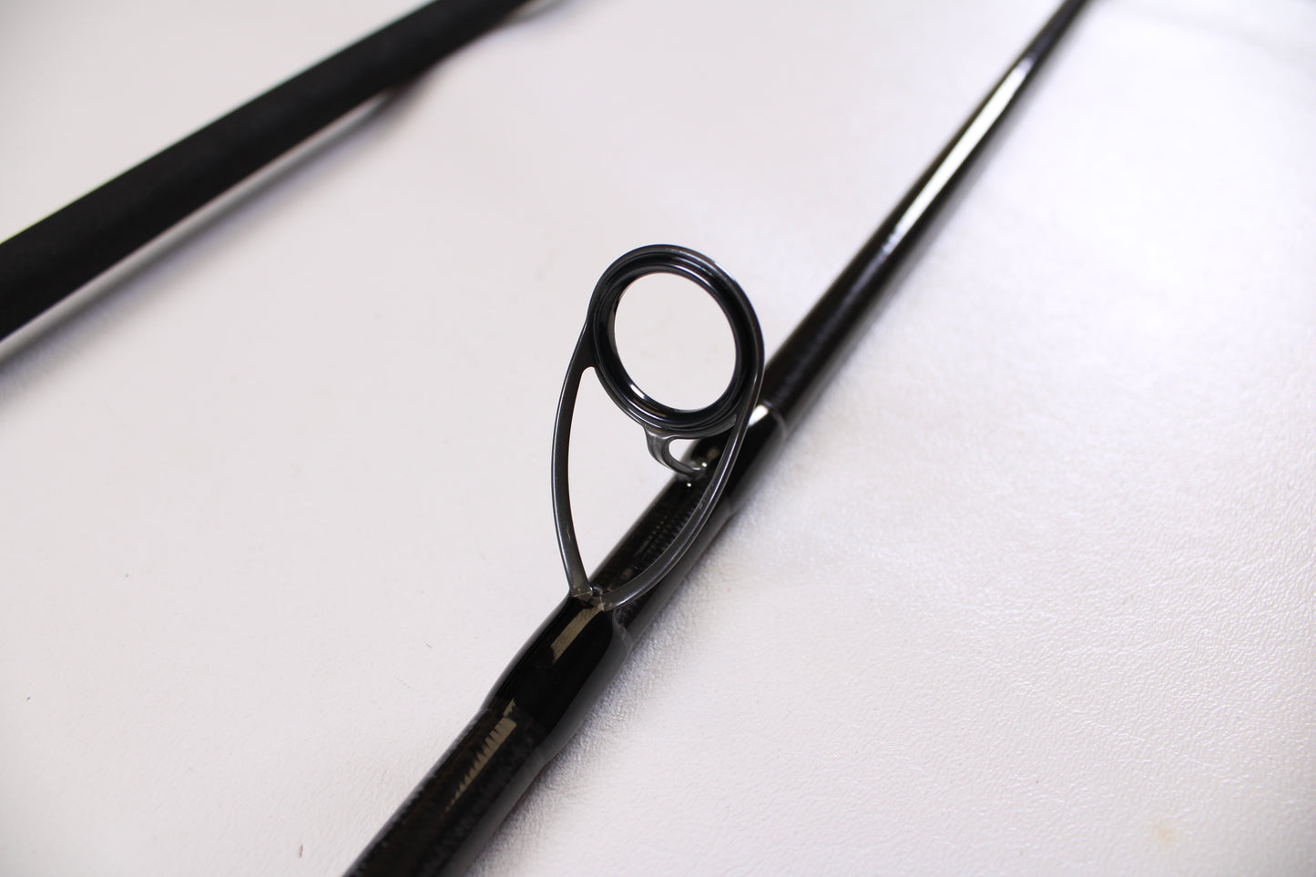 Close-up of a black guide on the ODM Rods Genesis Surf NGX-114 11'0" 2 Piece Used Spinning Rod in excellent condition—ideal for anglers seeking quality pre-owned gear from ODM Rods.