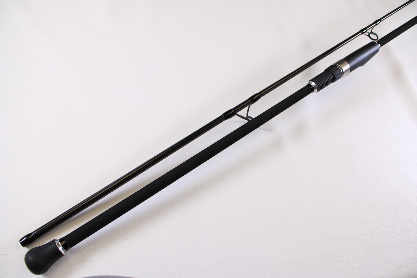 A close-up of the ODM Rods Genesis Surf NGX-9635 9'6" Used Spinning Rod in excellent condition, showing its padded handle and metal reel seat—great for those looking to upgrade or trade in their gear for store credit.