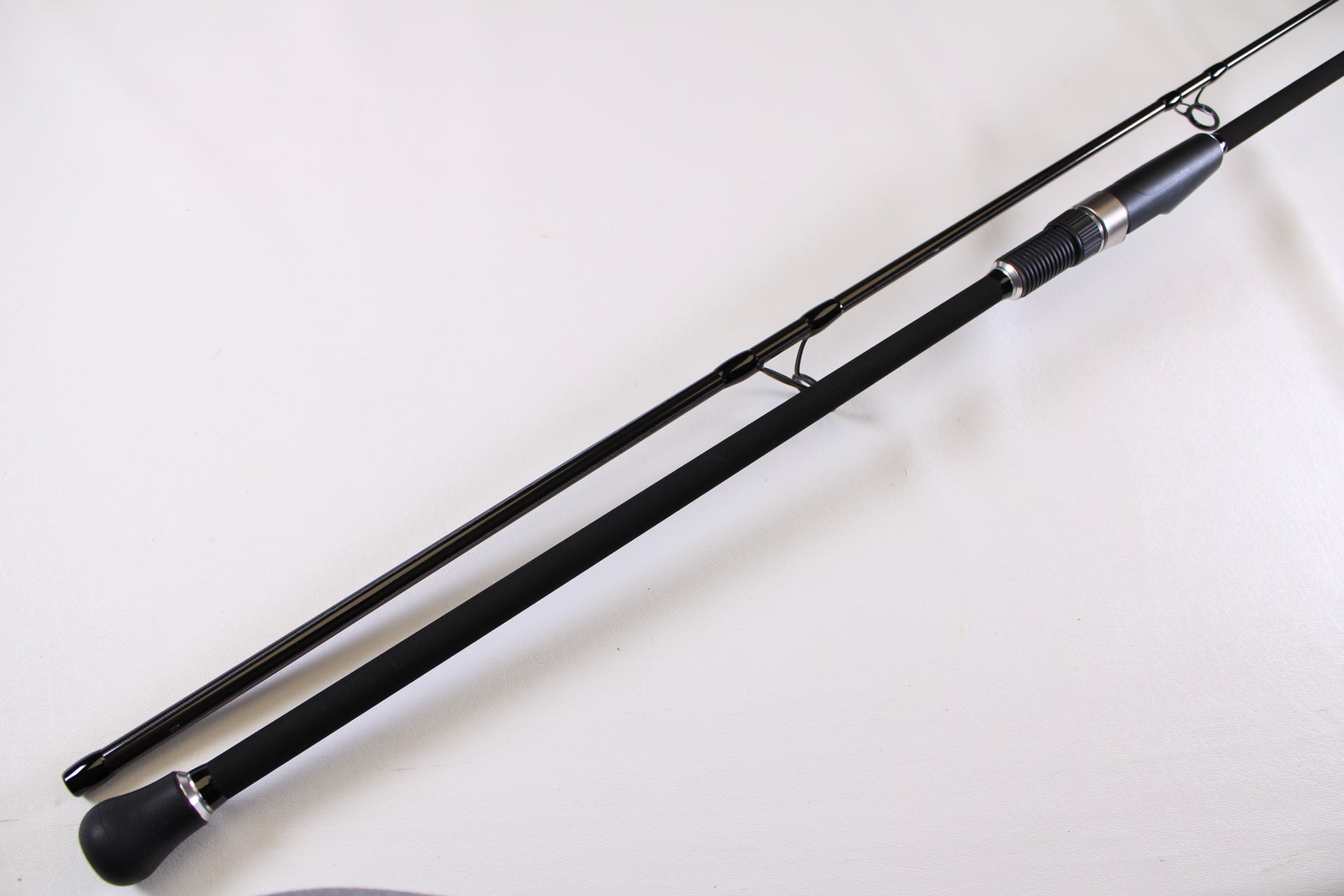 A close-up of the ODM Rods Genesis Surf NGX-9635 9'6" Used Spinning Rod in excellent condition, showing its padded handle and metal reel seat—great for those looking to upgrade or trade in their gear for store credit.