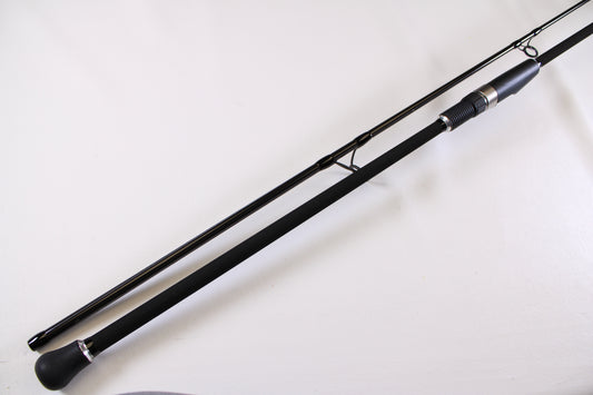 A close-up of the ODM Rods Genesis Surf NGX-9635 9'6" Used Spinning Rod in excellent condition, showing its padded handle and metal reel seat—great for those looking to upgrade or trade in their gear for store credit.