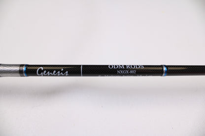 Close-up of the ODM Rods Genesis Surf NGX-802 8'0" 2 Piece Used Spinning Rod (Excellent Condition), labeled "Genesis," "ODM RODS," and "NXGX-802"—ideal for quality gear seekers or our Rod and Reel Trade-In Program.