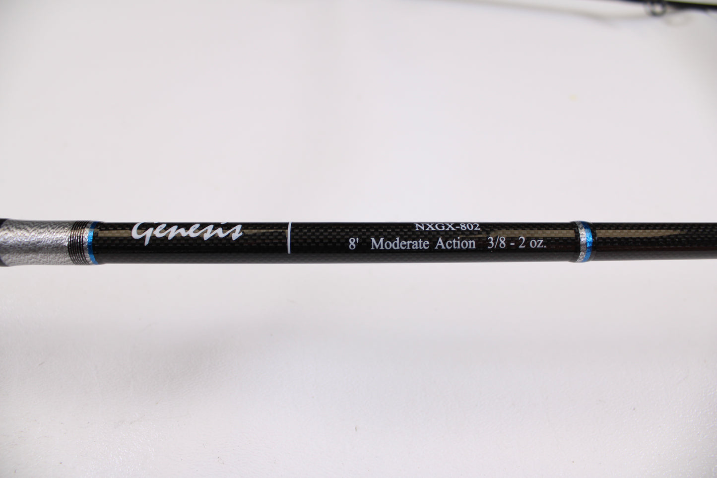 Close-up of an ODM Rods Genesis Surf NGX-802 8'0" 2-piece used spinning rod in excellent condition, featuring blue and silver accents—ideal for our Rod and Reel Trade-In Program or great used gear deals.
